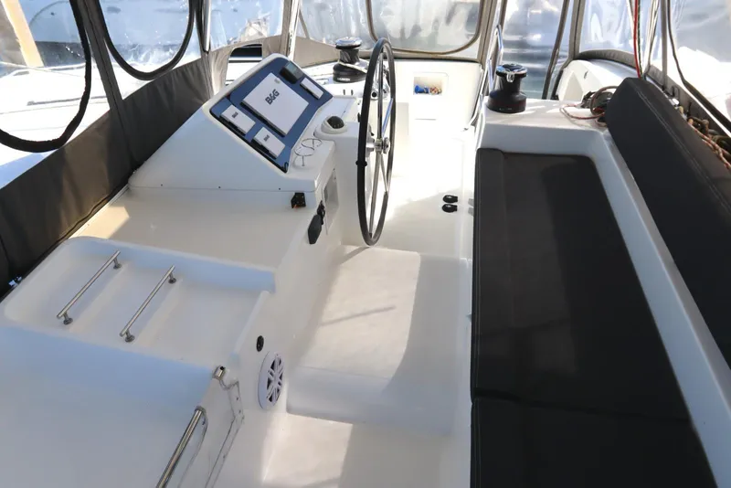 Slide: The Image of 2017 Lagoon 450 F yacht cockpit with steering wheel and navigation controls. - 49