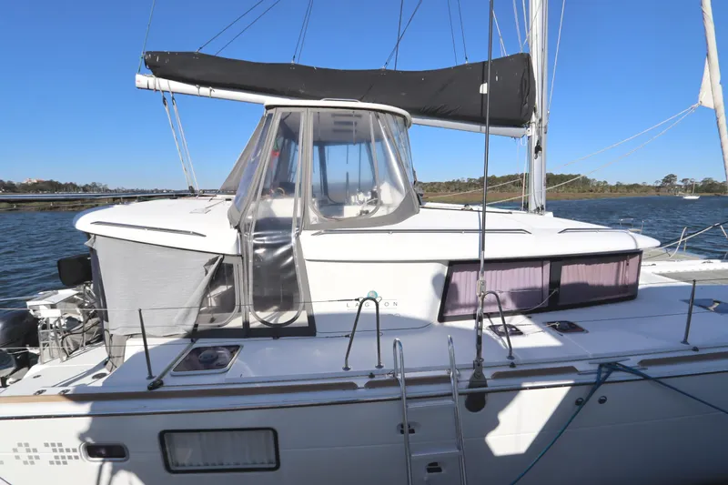 Slide: The Image of 2017 Lagoon 450 F catamaran on water, featuring sleek design and spacious deck. - 6