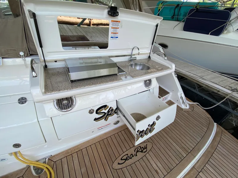 Slide: The Image of 2018 Sea Ray Sundancer 350 boat with outdoor kitchenette and storage on deck. - 10