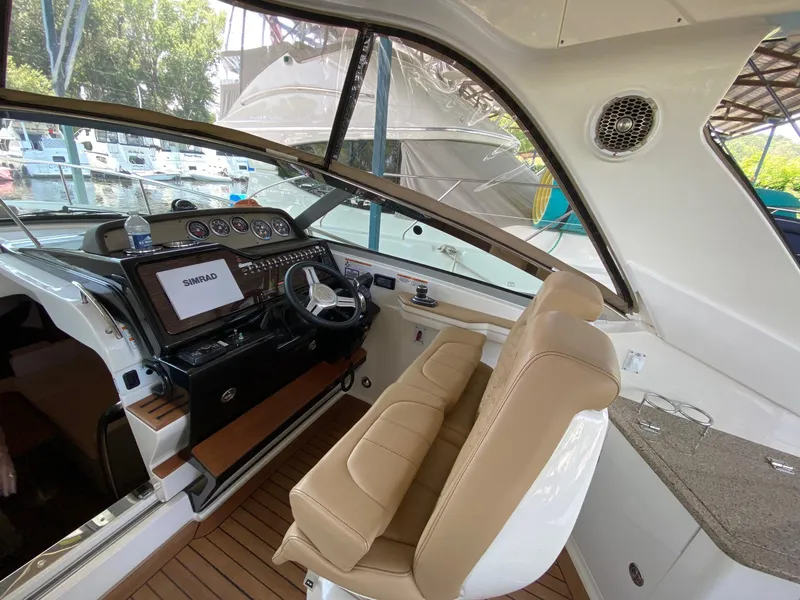 Slide: The Image of 2018 Sea Ray Sundancer 350 helm with leather seating and modern navigation system. - 17