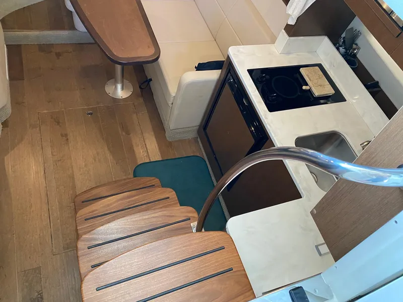 Slide: The Image of Interior of 2018 Sea Ray Sundancer 350 yacht with kitchen and seating area. - 24