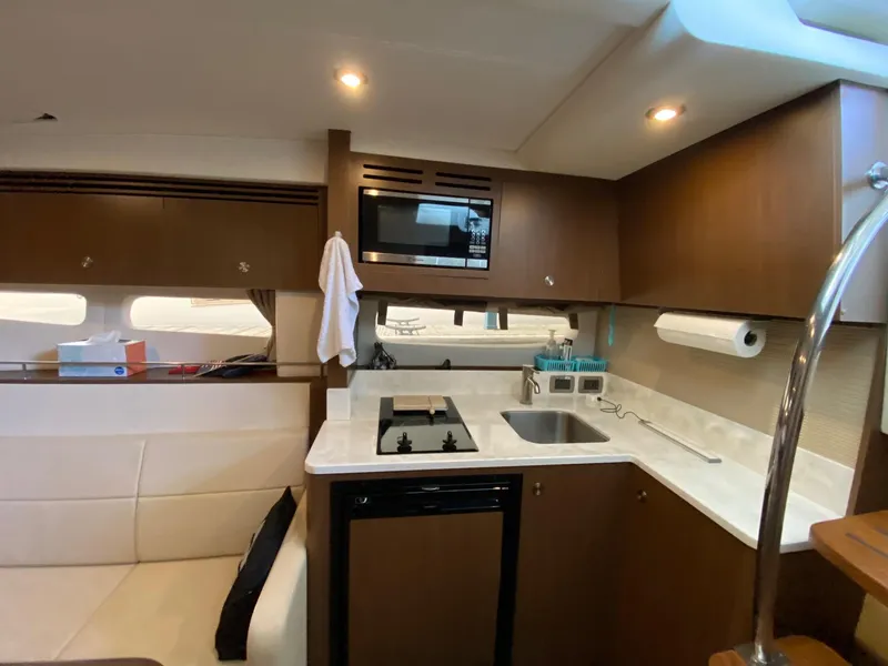 Slide: The Image of Modern kitchen interior of 2018 Sea Ray Sundancer 350 yacht with appliances and seating. - 25