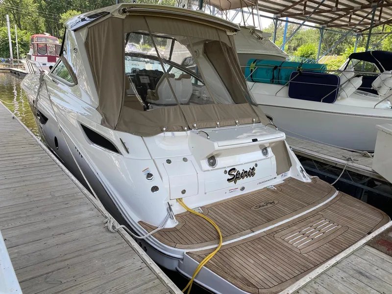 Slide: The Image of 2018 Sea Ray Sundancer 350 docked, featuring a sleek design and spacious deck area. - 3