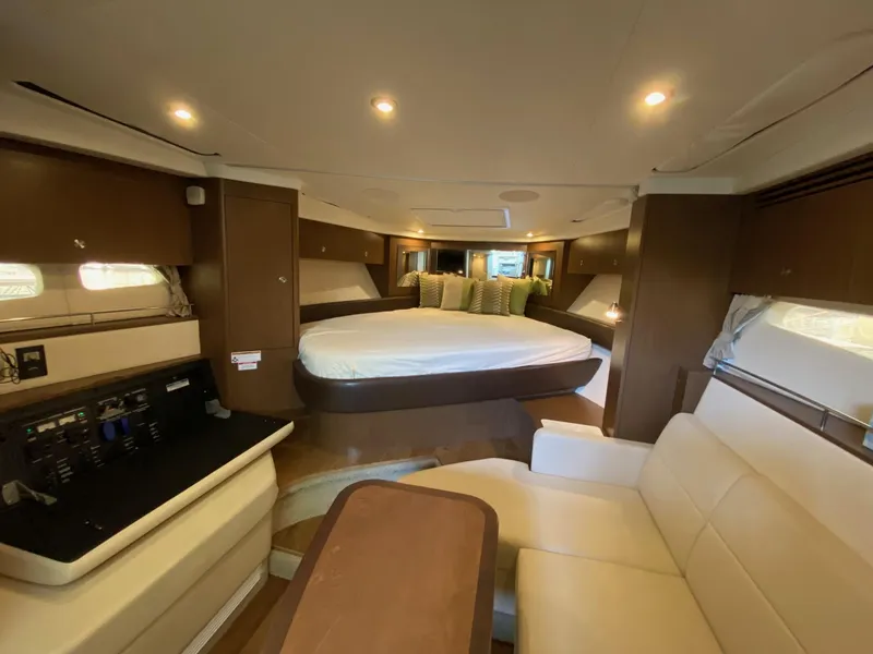 Slide: The Image of 2018 Sea Ray Sundancer 350 cabin interior with bed, seating, and ambient lighting. - 30