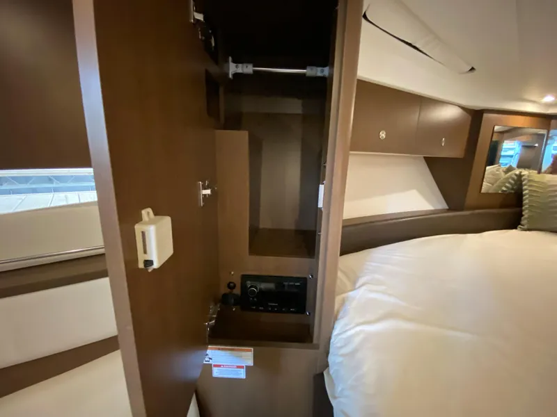 Slide: The Image of Interior cabin of 2018 Sea Ray Sundancer 350 with open closet and bed. - 34