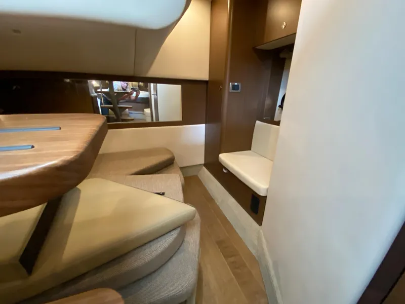 Slide: The Image of Interior of 2018 Sea Ray Sundancer 350 yacht, featuring seating and wooden accents. - 38