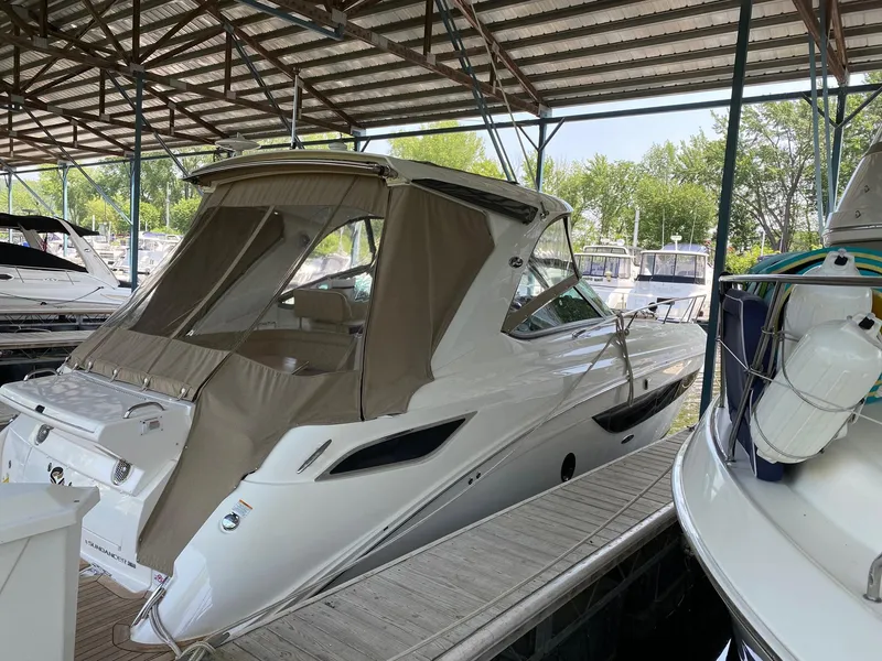 Slide: The Image of 2018 Sea Ray Sundancer 350 docked under a covered marina. - 4