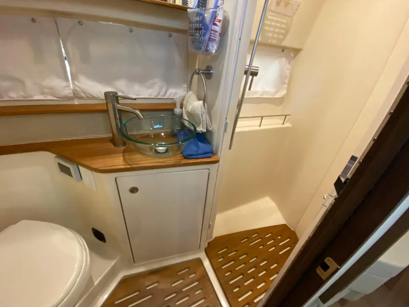 Slide: The Image of 2018 Sea Ray Sundancer 350 bathroom with modern fixtures and wooden accents. - 41