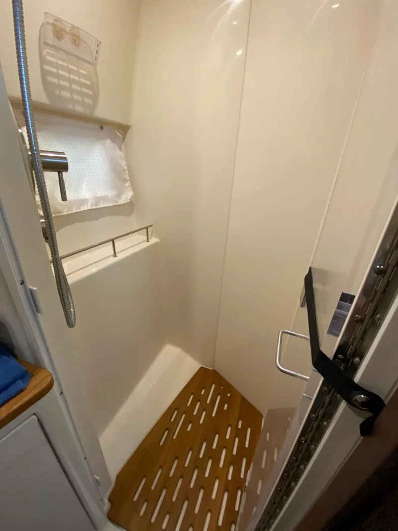 Slide: The Image of 2018 Sea Ray Sundancer 350 shower with wooden floor mat and modern fixtures. - 42