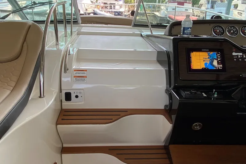 Slide: The Image of 2018 Sea Ray Sundancer 350 helm with navigation system and seating area. - 43