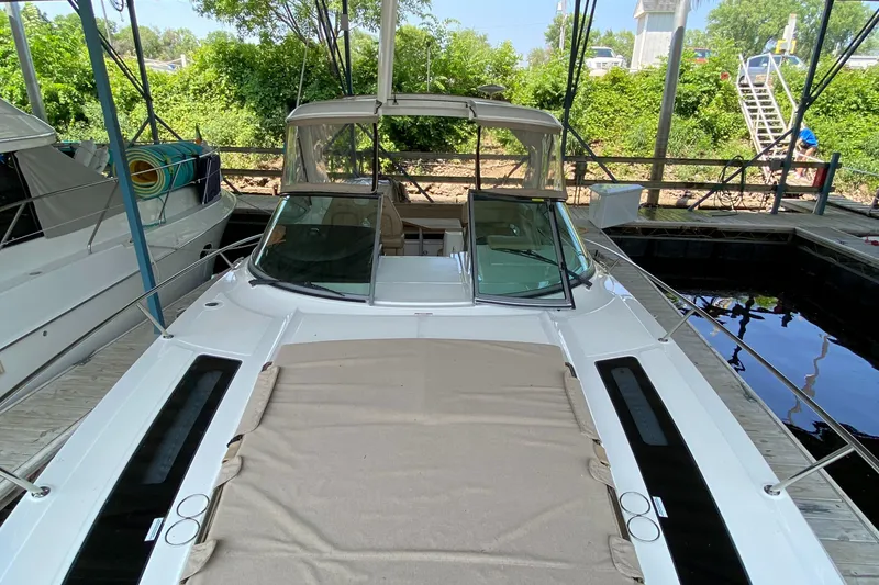Slide: The Image of 2018 Sea Ray Sundancer 350 yacht docked, featuring spacious deck and canopy. - 47