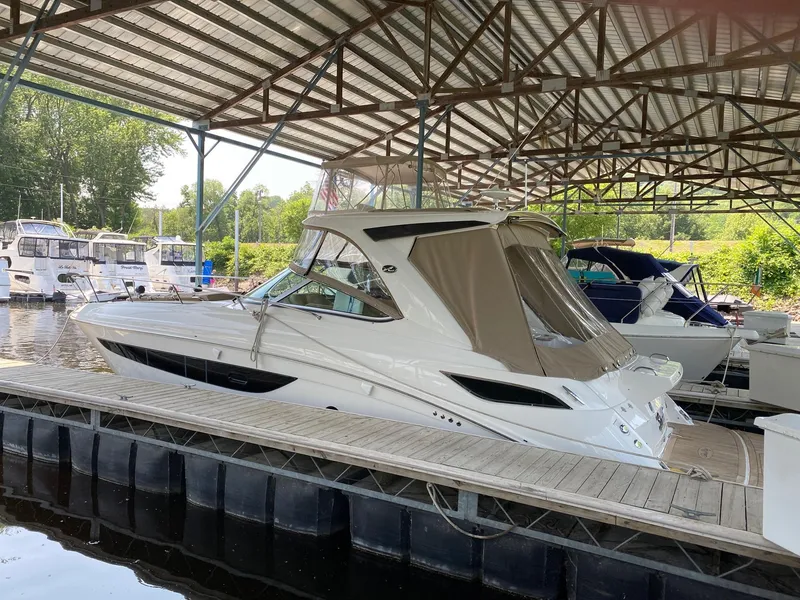 Slide: The Image of 2018 Sea Ray Sundancer 350 docked under a covered marina. - 5
