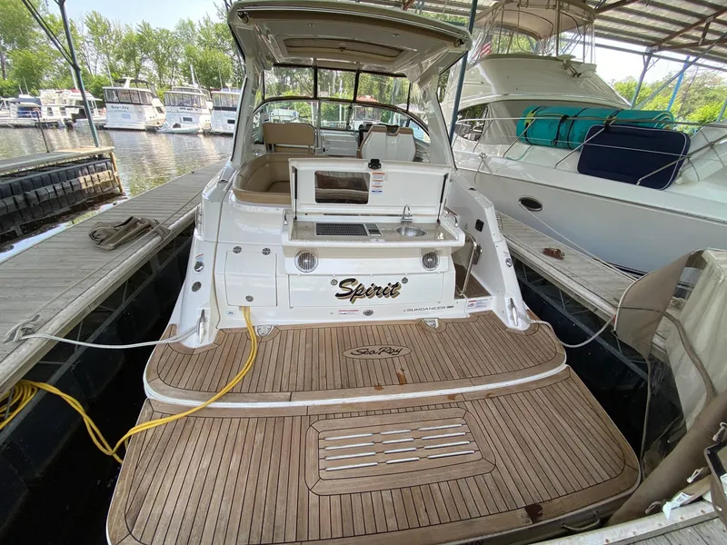 Slide: The Image of 2018 Sea Ray Sundancer 350 docked, featuring spacious deck and luxurious amenities. - 7