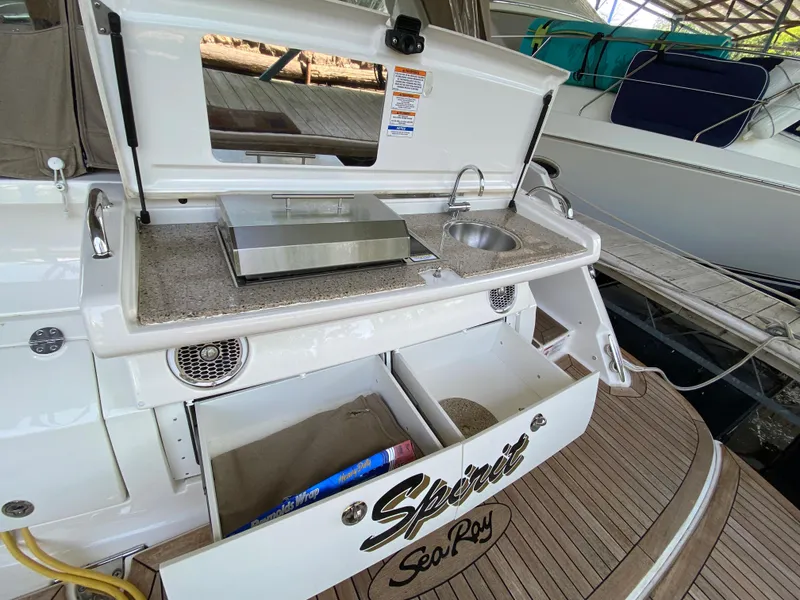 Slide: The Image of 2018 Sea Ray Sundancer 350 boat with outdoor kitchenette and storage drawers. - 9