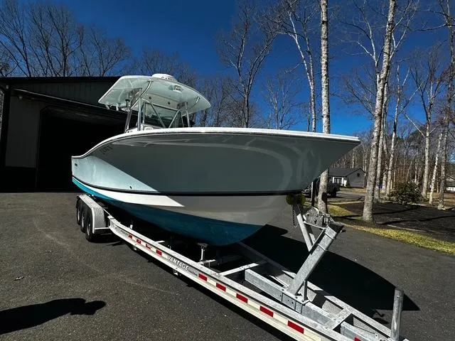 Slide: The Image of 2008 Regulator 29 Forward Seating boat on trailer, parked outdoors. - 1