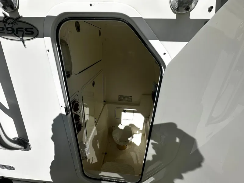 Slide: The Image of 2008 Regulator 29 Forward Seating boat interior with open door showing cabin space. - 11