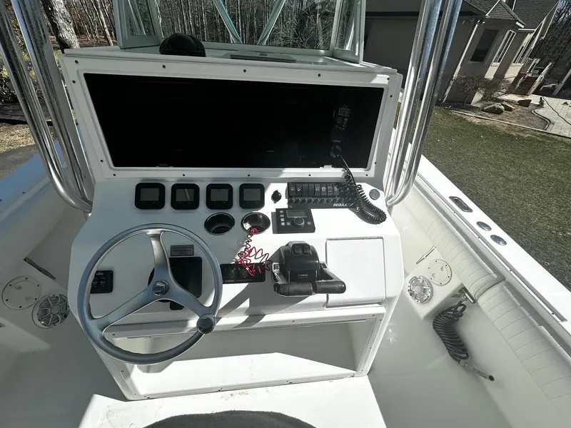 Slide: The Image of 2008 Regulator 29 Forward Seating boat console with steering wheel and controls. - 12