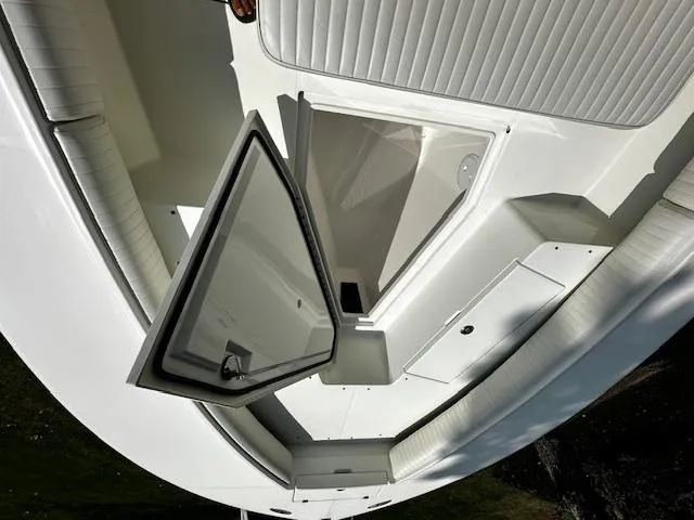 Slide: The Image of 2008 Regulator 29 Forward Seating boat with open storage compartment, white interior. - 22