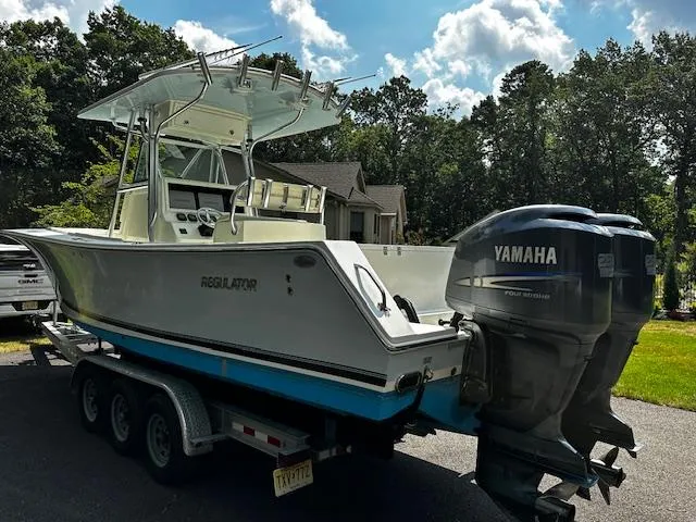 Slide: The Image of 2008 Regulator 29 Forward Seating boat with Yamaha engines on a trailer. - 4