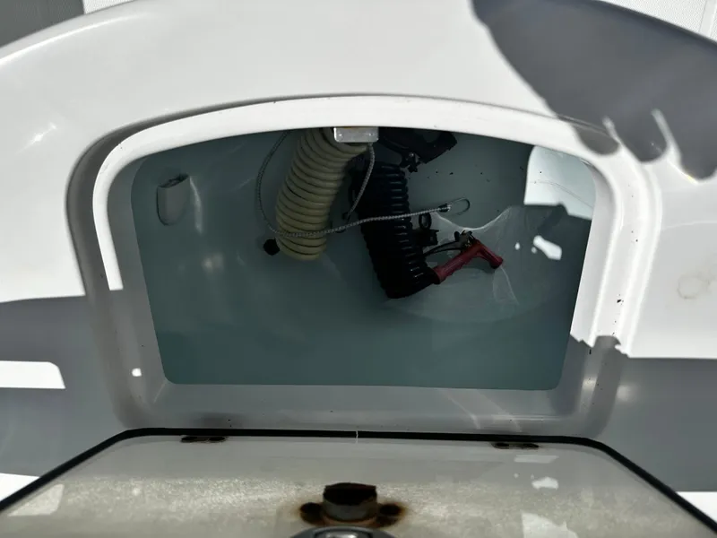 Slide: The Image of 2008 Regulator 29 Forward Seating boat compartment with visible wiring and hose. - 5