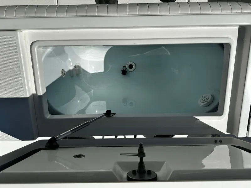 Slide: The Image of 2008 Regulator 29 Forward Seating boat livewell with open lid, showcasing interior features. - 8