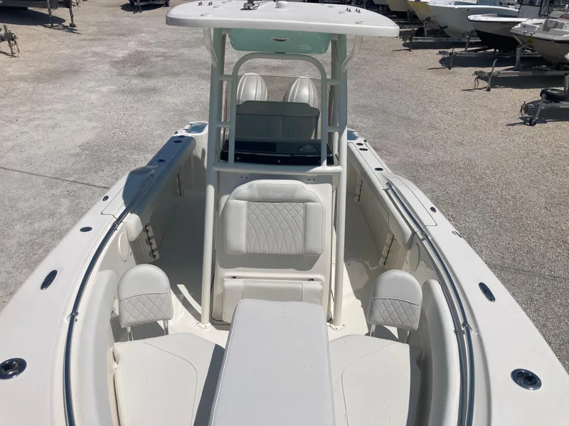 Slide: The Image of 2025 Key West 244CC boat with spacious seating and modern design in a marina setting. - 10