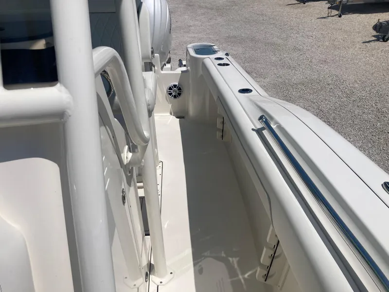Slide: The Image of 2025 Key West 244CC boat deck with white interior and stainless steel railings. - 12