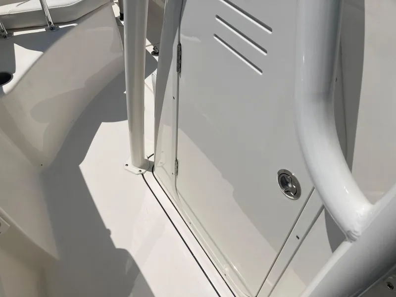 Slide: The Image of 2025 Key West 244CC boat interior, featuring sleek white design and storage compartment. - 13