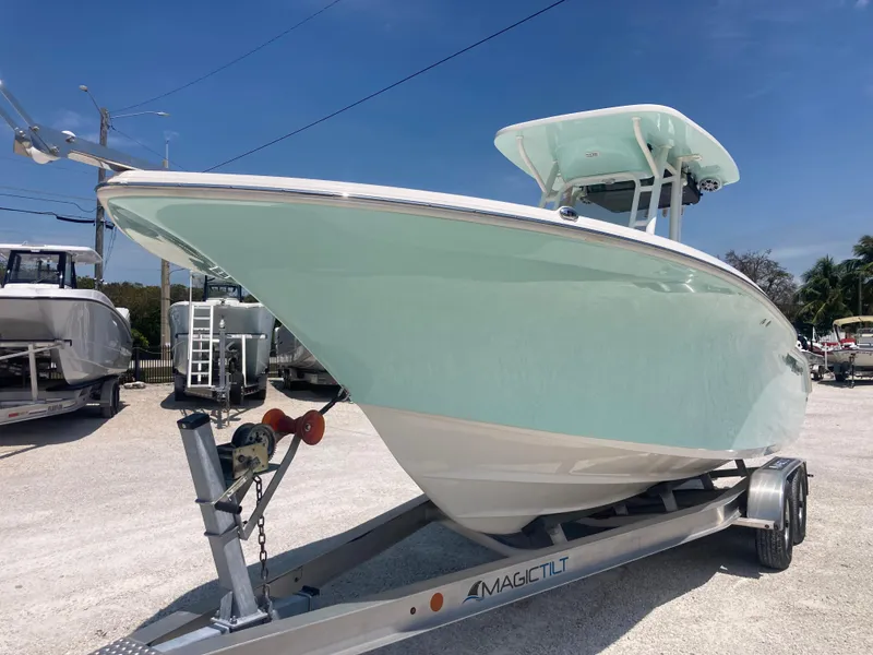 Slide: The Image of 2025 Key West 244CC boat on trailer, displayed outdoors under clear blue sky. - 4
