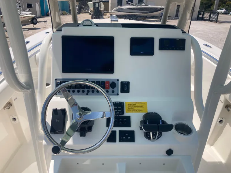 Slide: The Image of 2025 Key West 244CC boat dashboard with steering wheel and electronic controls. - 7