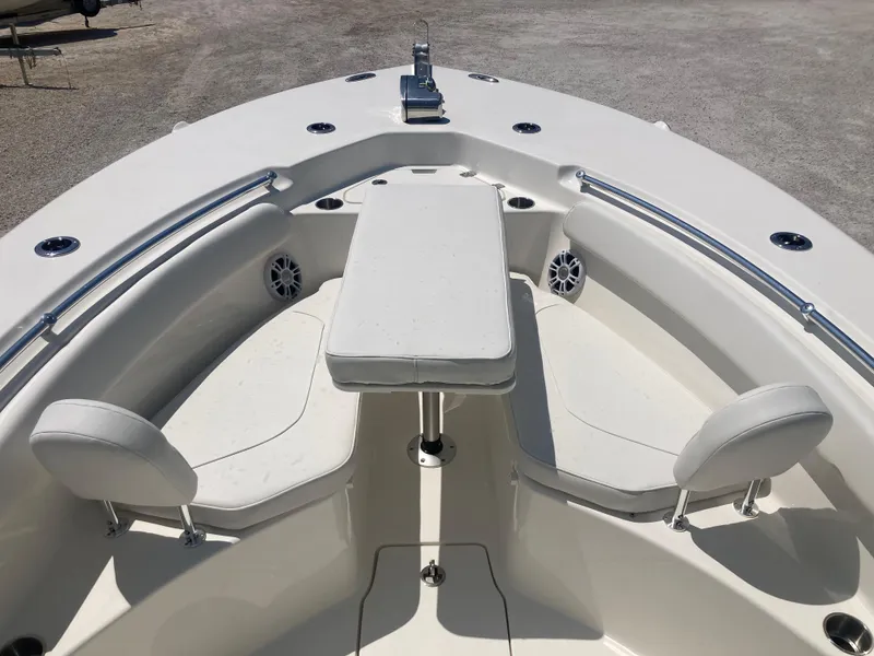 Slide: The Image of 2025 Key West 244CC boat interior with seating and table, featuring sleek white design. - 8