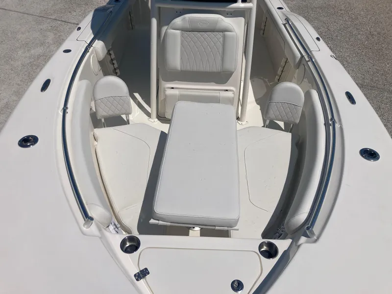 Slide: The Image of 2025 Key West 244CC boat interior with cushioned seating and table. - 9