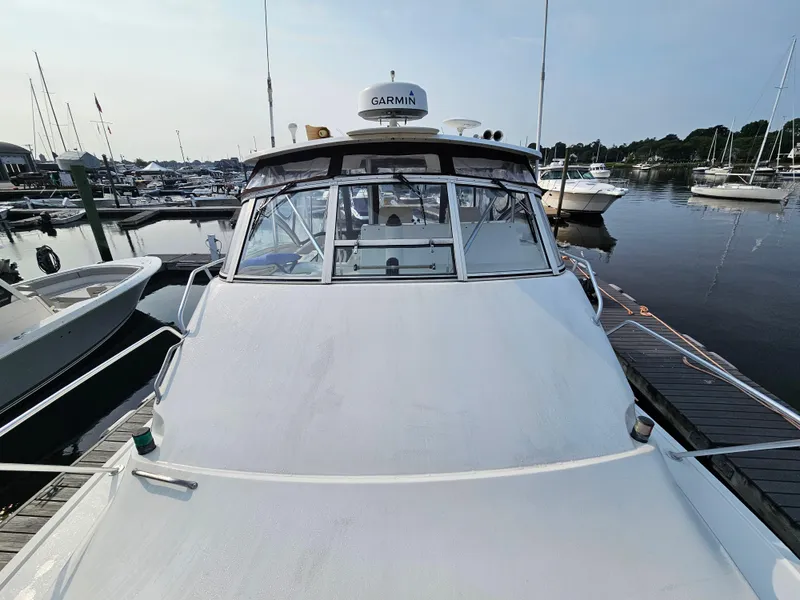 Slide: The Image of 1998 Ocean Yachts 40 docked at a marina, featuring Garmin equipment. - 10