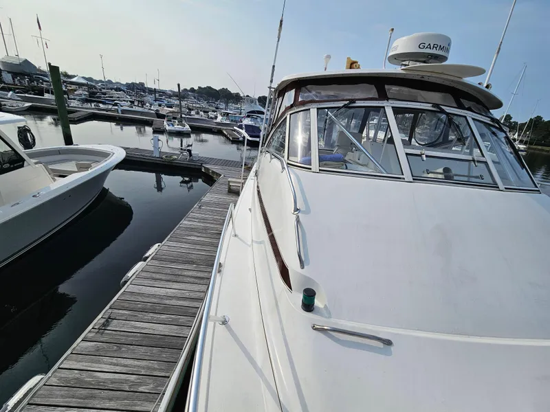 Slide: The Image of 1998 Ocean Yachts 40 docked at a marina, featuring sleek design and Garmin equipment. - 12