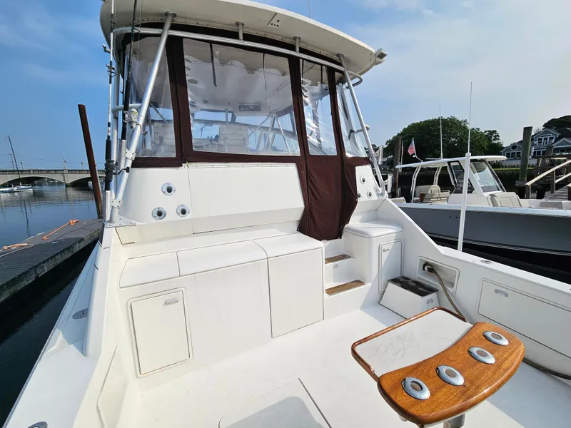 Slide: The Image of 1998 Ocean Yachts 40 boat docked, featuring spacious deck and seating area. - 16