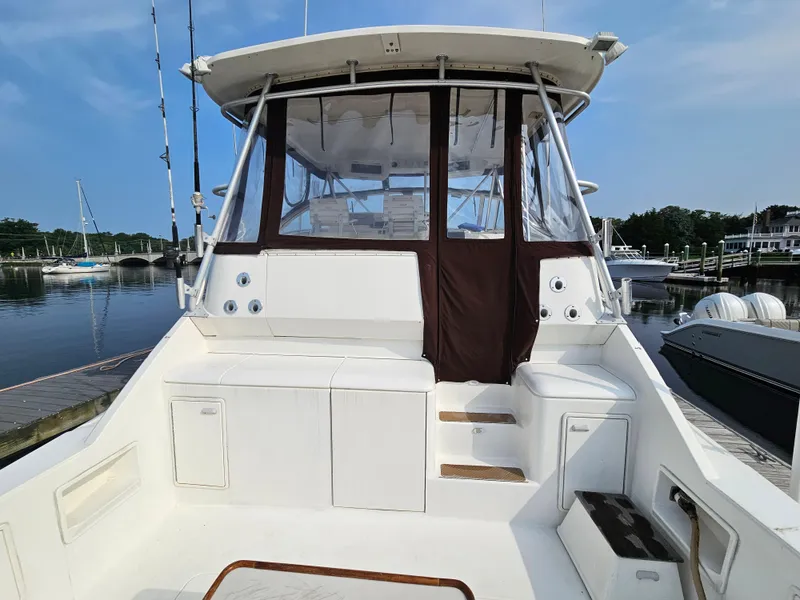 Slide: The Image of 1998 Ocean Yachts 40 boat with enclosed cockpit, docked at a marina. - 18