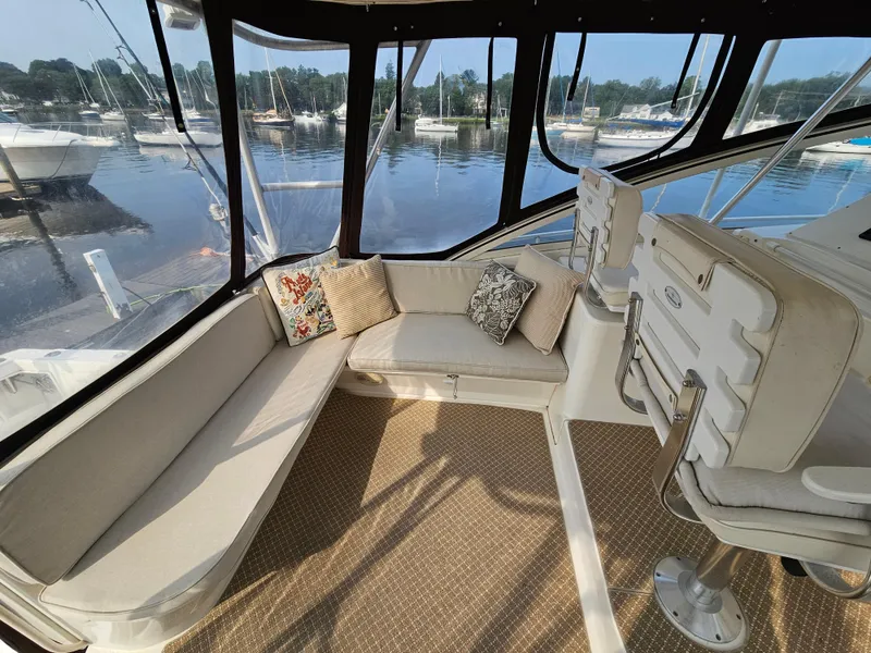 Slide: The Image of 1998 Ocean Yachts 40 interior with cushioned seating, overlooking marina. - 19
