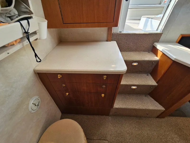 Slide: The Image of Interior of 1998 Ocean Yachts 40, featuring wooden cabinetry and carpeted stairs. - 25