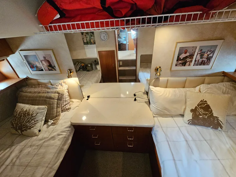 Slide: The Image of Cozy cabin interior of a 1998 Ocean Yachts 40, featuring twin beds and nautical decor. - 28