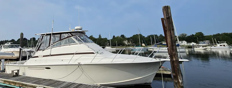 Slide: The Image of 1998 Ocean Yachts 40 docked at a marina, calm water, clear sky. - 3