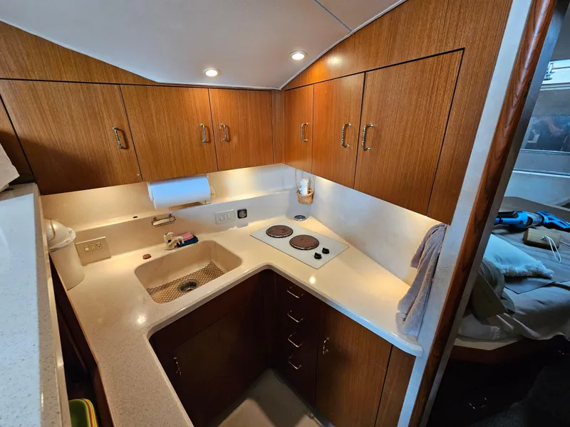 Slide: The Image of 1998 Ocean Yachts 40 galley with wooden cabinets and modern appliances. - 32