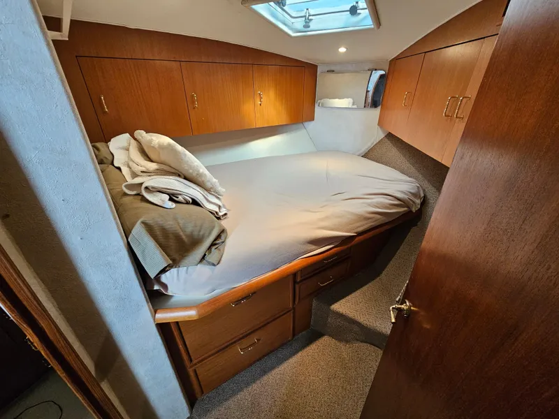 Slide: The Image of Cozy cabin interior of a 1998 Ocean Yachts 40, featuring a comfortable bed and wooden cabinetry. - 35