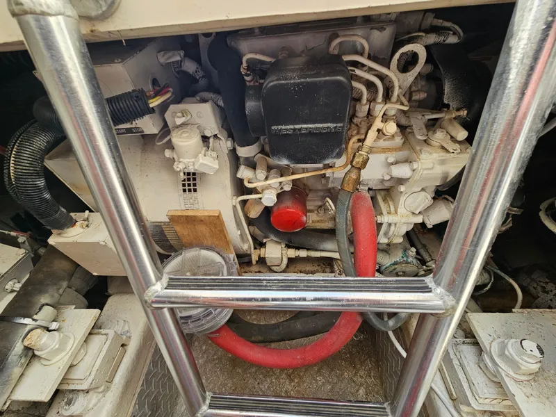 Slide: The Image of Engine compartment of a 1998 Ocean Yachts 40, featuring mechanical components and hoses. - 40