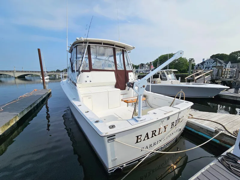 Slide: The Image of 1998 Ocean Yachts 40 docked at marina, featuring spacious deck and fishing equipment. - 6