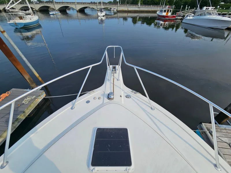 Slide: The Image of Bow view of 1998 Ocean Yachts 40 at a marina with calm waters. - 9