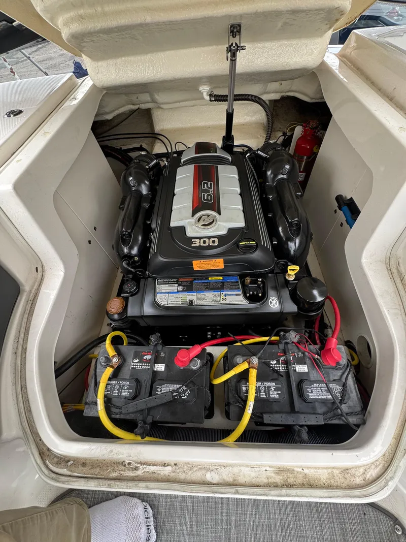 Slide: The Image of 2019 Chaparral 246 SSi engine compartment with 300 horsepower engine and dual batteries. - 14
