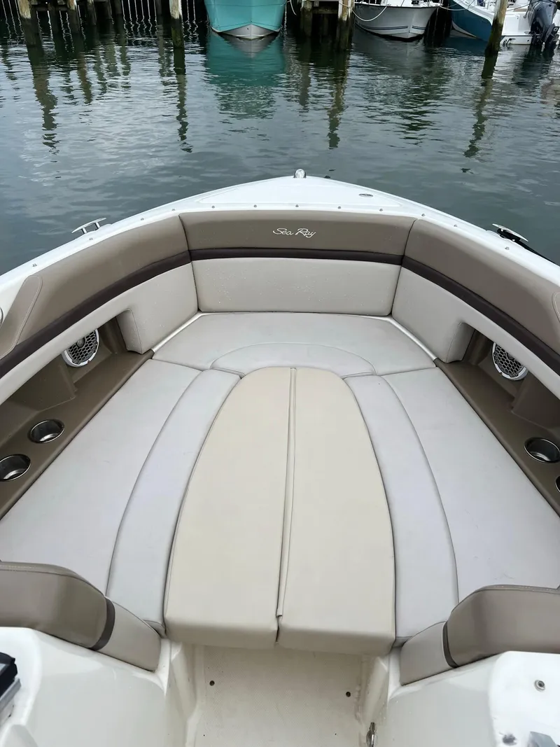 Slide: The Image of 2011 Sea Ray 270 SLX boat with spacious seating, docked by the water. - 10