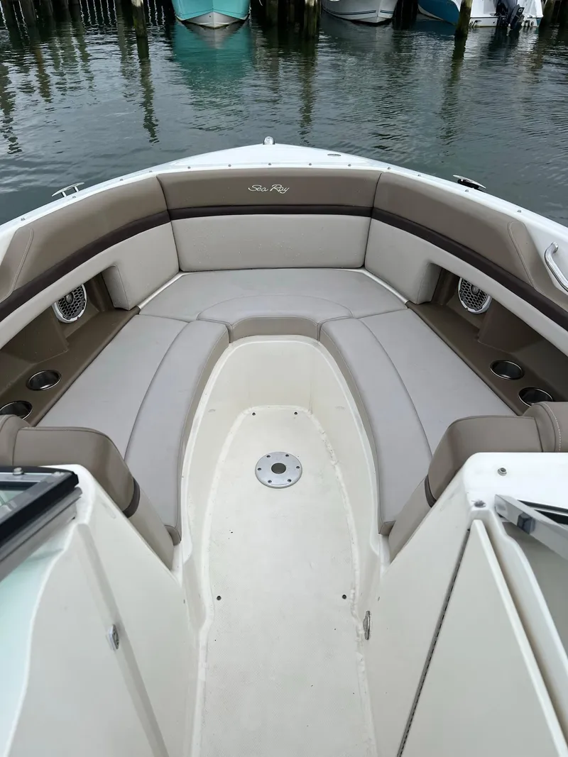 Slide: The Image of 2011 Sea Ray 270 SLX boat interior with cushioned seating and cup holders. - 15
