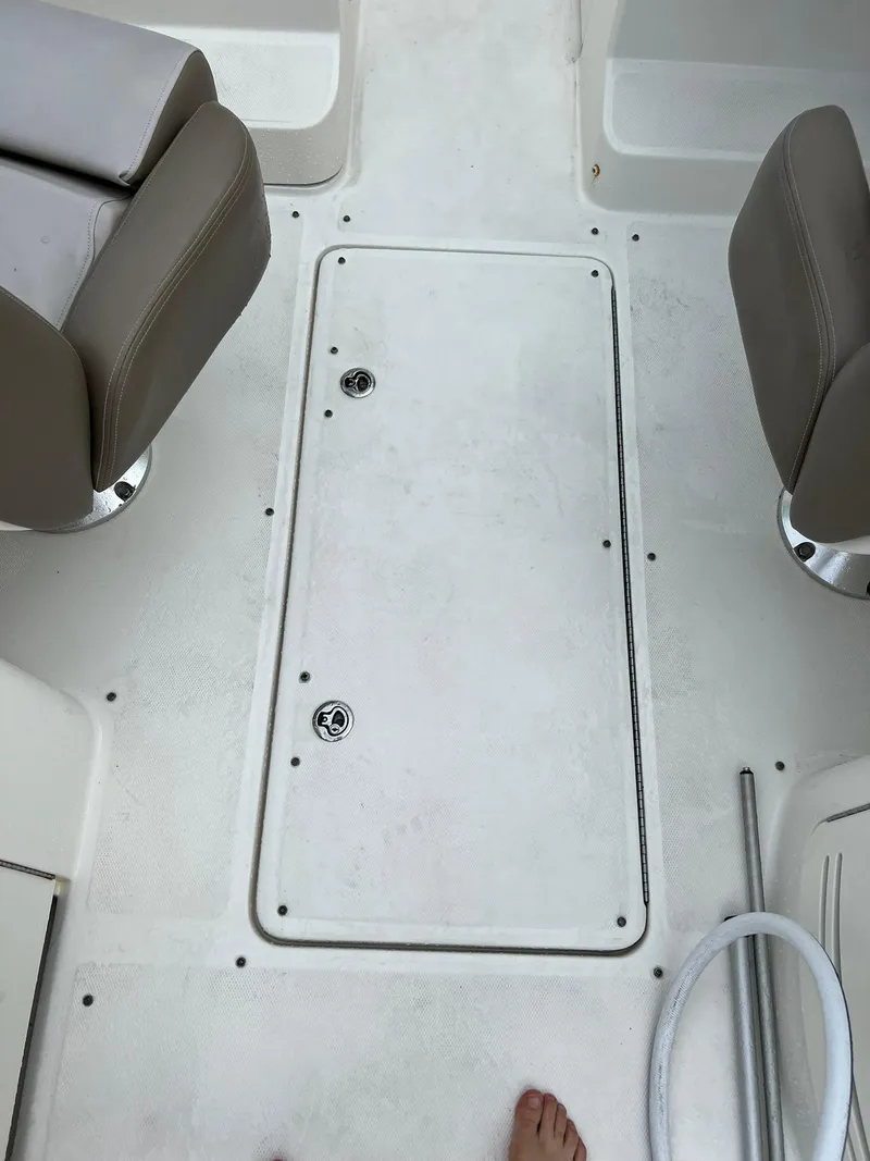 Slide: The Image of 2011 Sea Ray 270 SLX boat deck with seating and storage hatch. - 16