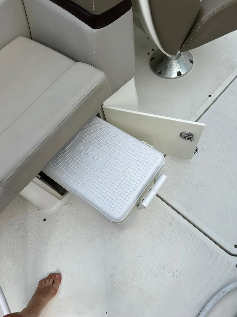 Slide: The Image of 2011 Sea Ray 270 SLX boat interior with cooler storage under seat. - 18